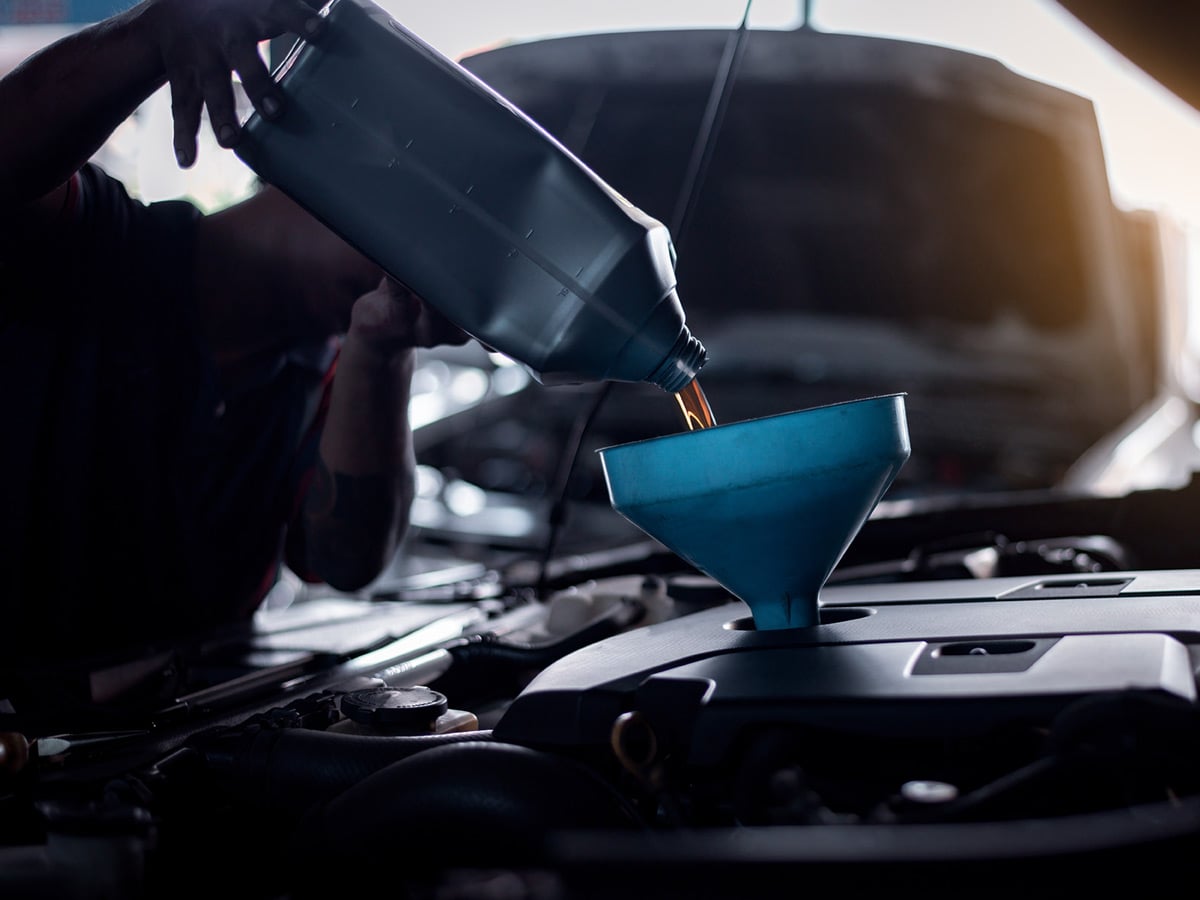 An oil change being carried out with genuine Kia parts, the routine maintenance that keeps a warranty valid