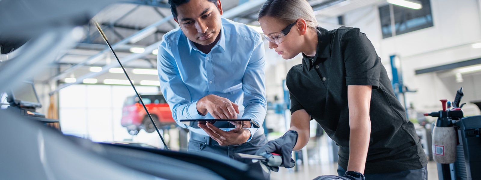 A Scarboro Kia service advisor going through a vehicle's health check with an owner