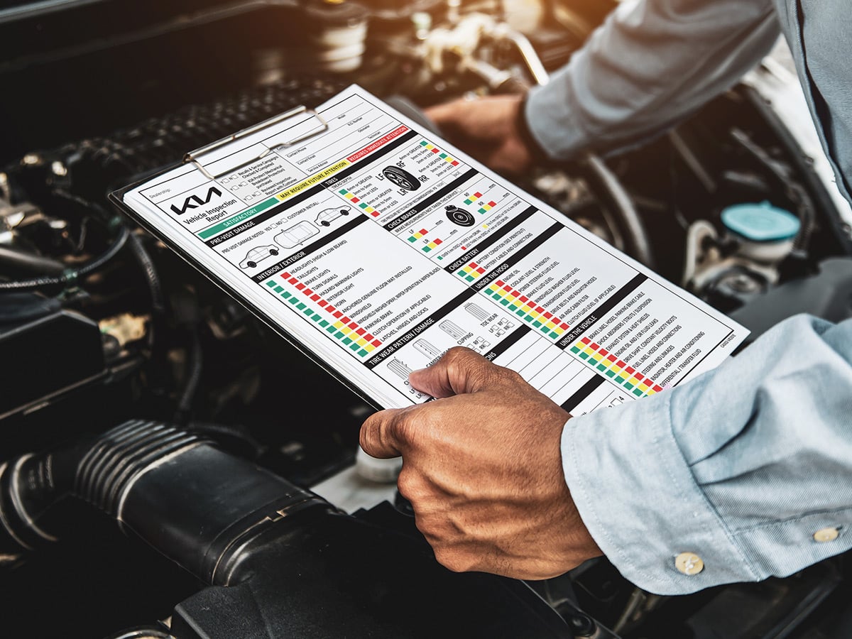 A Kia multi-point inspection sheet being completed, the checks that sit behind your warranty coverage