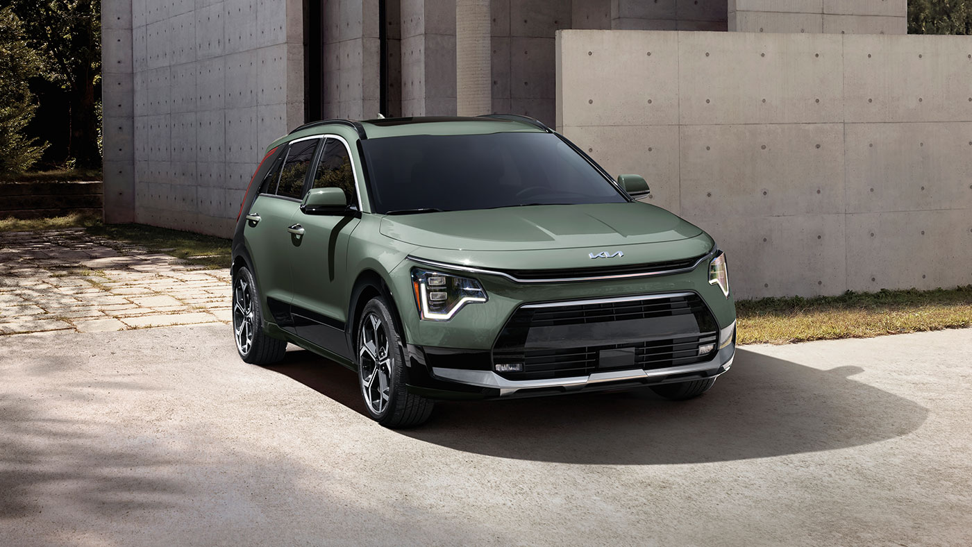 Front exterior of Niro Hybrid SX in Cityscape Green with LED headlights.